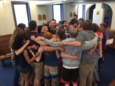 Students hugging in a circle
